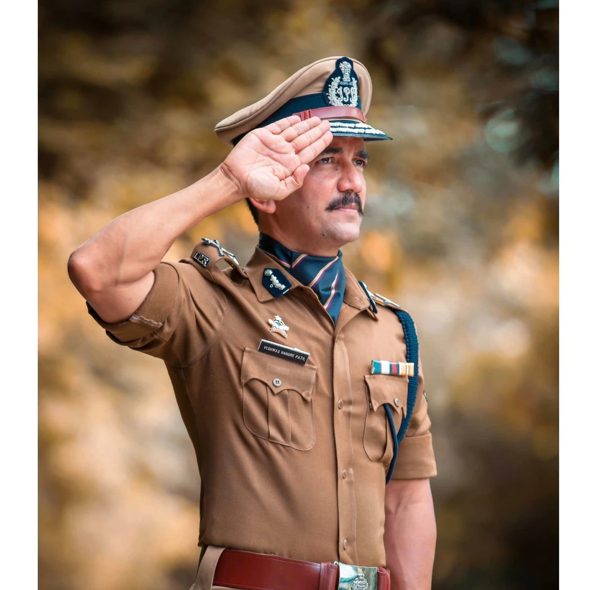 Vishwas Nangre Patil in Indian Police Service uniform and peaked cap, saluting