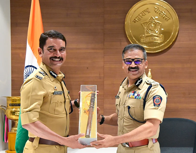 Vishwas Nangre Patil receiving a ceremonial baton from a senior police officer at a handover