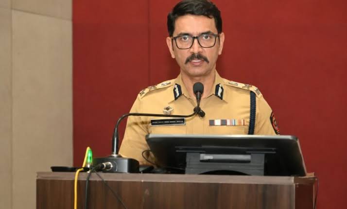 Vishwas Nangre Patil in uniform addressing an audience from a podium with a microphone