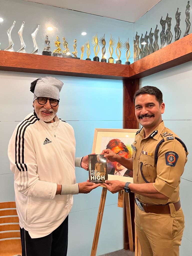 Vishwas Nangre Patil in uniform presenting a copy of his book Head Held High