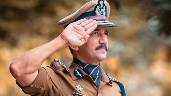 Vishwas Nangre Patil in ceremonial uniform and peaked cap, saluting
