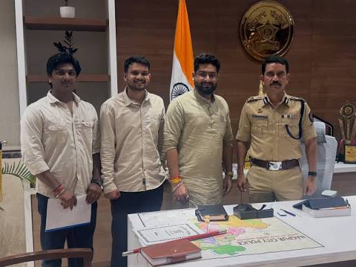 Vishwas Nangre Patil in uniform standing with three visitors in his office at Nagpur City Police headquarters
