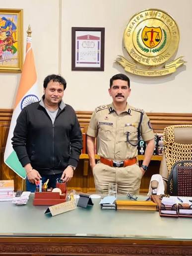 Vishwas Nangre Patil in uniform standing with a visitor in an office at Greater Mumbai Police